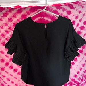 BLACK BLOUSE WITH RUFFLE SLEEVES.